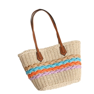 Bohemian straw tote bag with colorful stripes and slim brown faux leather handles