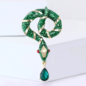 Exquisite gold-tone snake brooch with green enamel and a teardrop-shaped gemstone charm