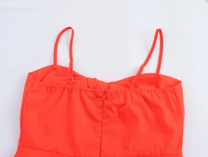 Detail view of red dress back with adjustable straps, hidden zipper and elastic ruching