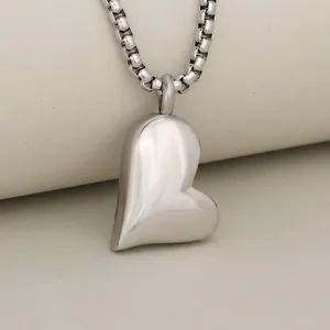 Detailed size view of heart urn pendant in polished steel measuring 26.6mm by 17.9mm