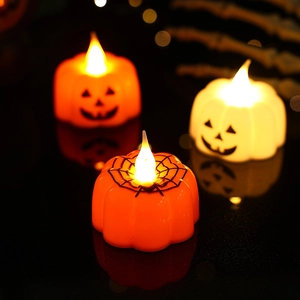 Macro view of orange and white Halloween LED pumpkin candles with spider web pattern