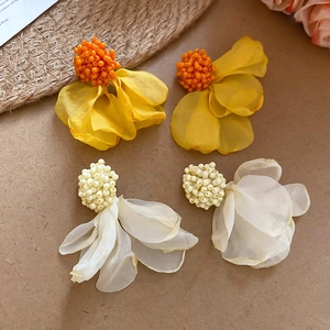 Detail of yellow and white chiffon flower earrings with handcrafted bead accents