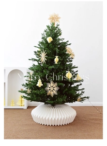 Modern white accordion paper tree skirt detail on a rustic Scandinavian Christmas tree