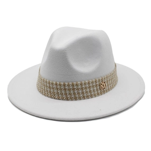 White wool fedora hat with a tweed band and a round golden metal M logo emblem