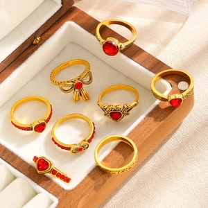 7-piece vintage gold ring set featuring red heart crystals and bow knot designs