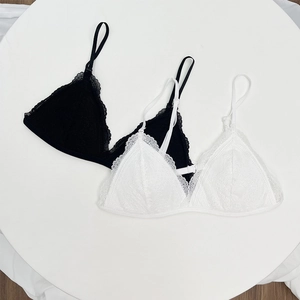 Detailed top view of black and white lace triangle bralettes with eyelash trim