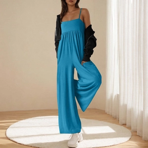 Detail of bright blue wide-leg jumpsuit with waist pleats and square neckline