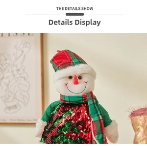 Detailed view of sequined snowman plush with red and green sequins and checkered scarf