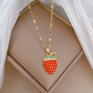 Elegant gold strawberry pendant necklace with red enamel and crystals in a gift box