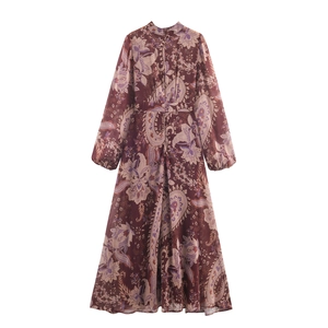 Detail of bohemian paisley print on a burgundy chiffon dress with pleated front chest design