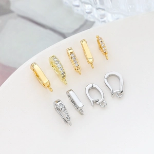 Macro view of gold and silver plated connector clasps with cubic zirconia for DIY jewelry