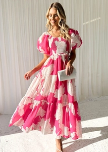 Detail of rose red floral maxi dress with bubble sleeves and tiered cake hem design