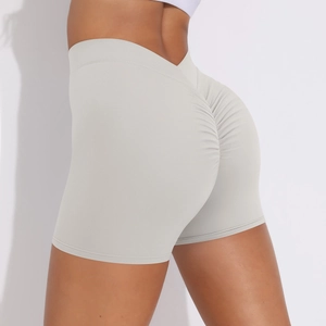 Detail view of high waisted yoga shorts with ruched scrunch butt design in light grey