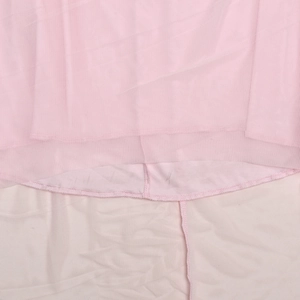 Detail of pink mesh and solid fabric layers with precision stitching on a summer dress