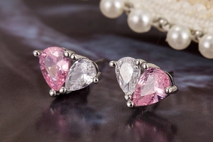 Detailed close-up of teardrop cut pink and clear zircon earrings in silver setting