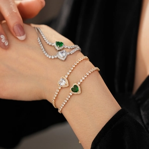Close-up of elegant heart-shaped zircon tennis bracelets in gold and silver finishes