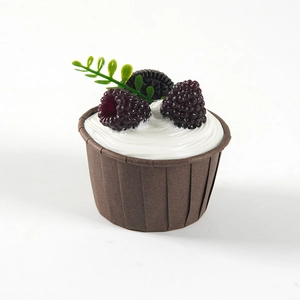 Realistic faux cupcake prop with creamy white frosting, mulberries, and mini cookie topping