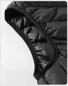 Close-up of quilted vest armhole with black elastic binding and semi-matte texture