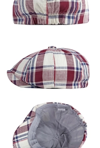 Detail view of red and blue plaid baker boy hat showing interior lining and elastic back