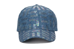 Macro shot of blue denim baseball cap with colorful holographic Queen letter prints