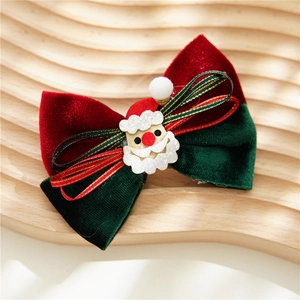 Detail of Christmas velvet bow hair clip featuring a glittery Santa Claus and white pom-pom