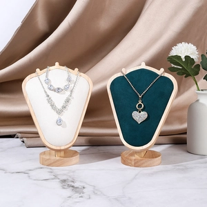 Detailed view of luxury velvet portrait bust display with natural wood frame for necklaces