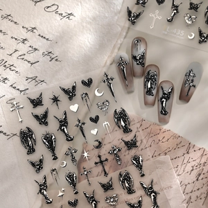 Gothic black angel nail stickers with metallic silver crosses and stars on gradient nails