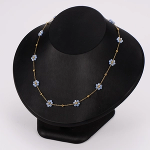 British style stainless steel beaded flower necklace set on black jewelry display