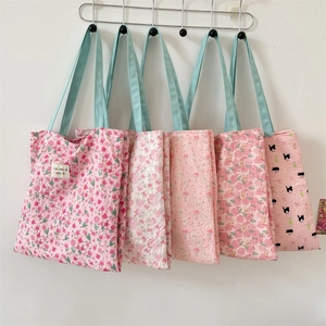 Detailed view of quilted canvas tote bags with cartoon bear and floral prints