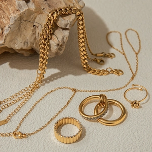 Artistic layout of 18K gold plated stainless steel jewelry set with rings and chains