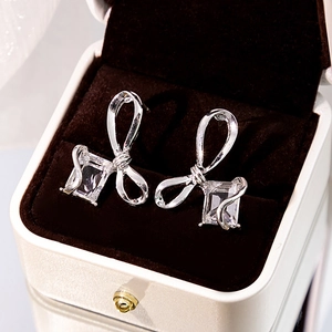 Elegant silver bow stud earrings with sparkling baguette-cut cubic zirconia in a gift box