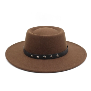 Detail of brown wool flat top fedora featuring black band with star metal rivets