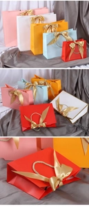Colorful gift paper bags with gold bows and braided handles in various sizes for jewelry