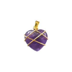 Detailed macro view of heart-shaped amethyst pendant wrapped in golden wire craft