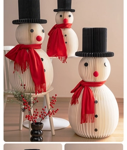 Detailed honeycomb paper snowmen decorations with red knitted scarves and black felt hats