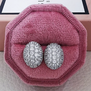 Elegant silver-tone hollow oval stud earrings with pavé cubic zirconia in a pink box
