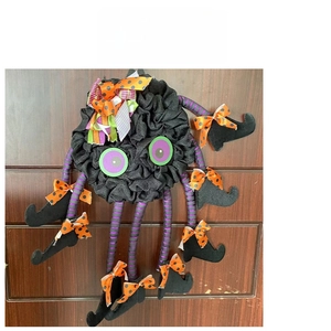 Detail of Halloween spider door wreath with purple striped legs and wizard boots