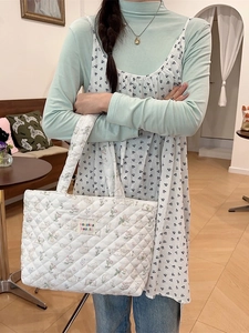 Quilted cotton tote bag with floral rabbit pattern shown in a lifestyle model display