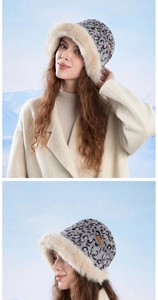 Detailed view of plush leopard print bucket hat with beige faux fur brim and leather tag