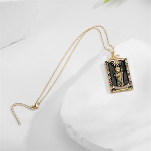 Macro detail of tarot style gold pendant necklace with colorful cubic zirconia and sun motif