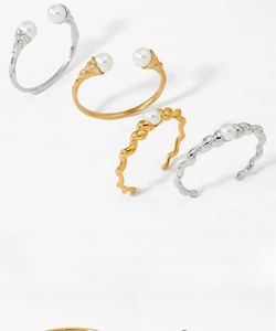 Close-up of gold and silver irregular pearl rings with wave texture and open bands