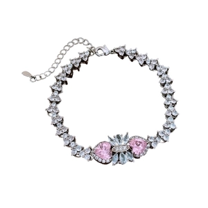 Elegant silver bracelet with pink heart-shaped zircons and light blue accents on white background