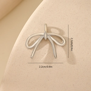 Detailed view of a silver bow pendant with zircon inlays and precise size dimensions