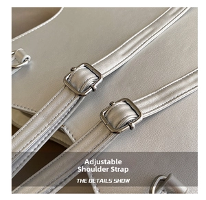 Close-up of adjustable straps with metallic hardware on a silver designer star bag