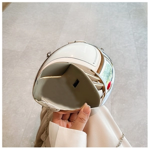 Detail of silver metallic and white acrylic mini crossbody bag with metal chain strap