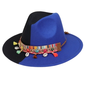 Detail of bohemian wool fedora featuring colorful tassels, seashells and woven band decor