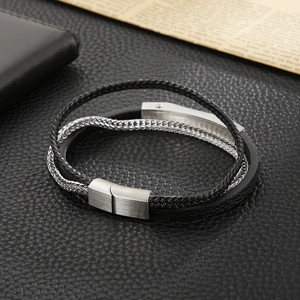 Detail of multi-layer black leather bracelet with silver metal chains and magnetic clasp
