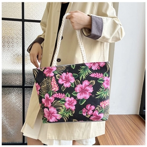Detailed shot of tropical hibiscus print canvas tote bag with white hemp rope handles