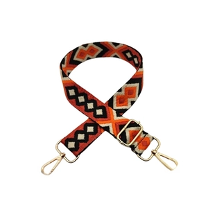 Detail of adjustable 3.8cm woven strap with orange geometric patterns and gold metal clips