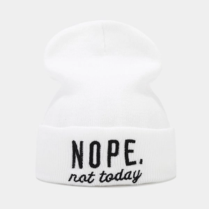 Close-up of white knit beanie featuring black 'NOPE. not today' slogan embroidery detail